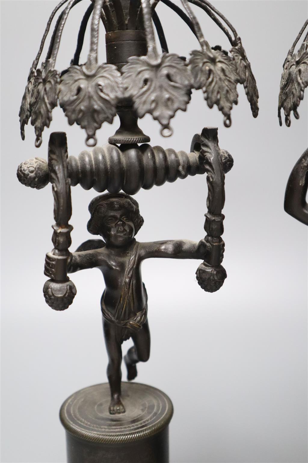 Two early 19th century bronze figural candlesticks (lacking glass lustres), 37.5cm